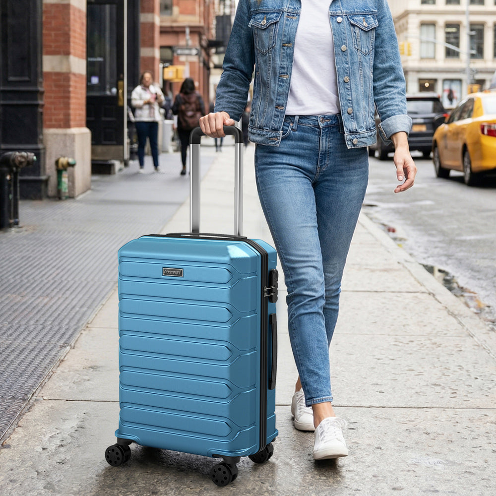 Lightweight blue hardside suitcase with 8-spinner wheels, perfect for travel, shown on city street.