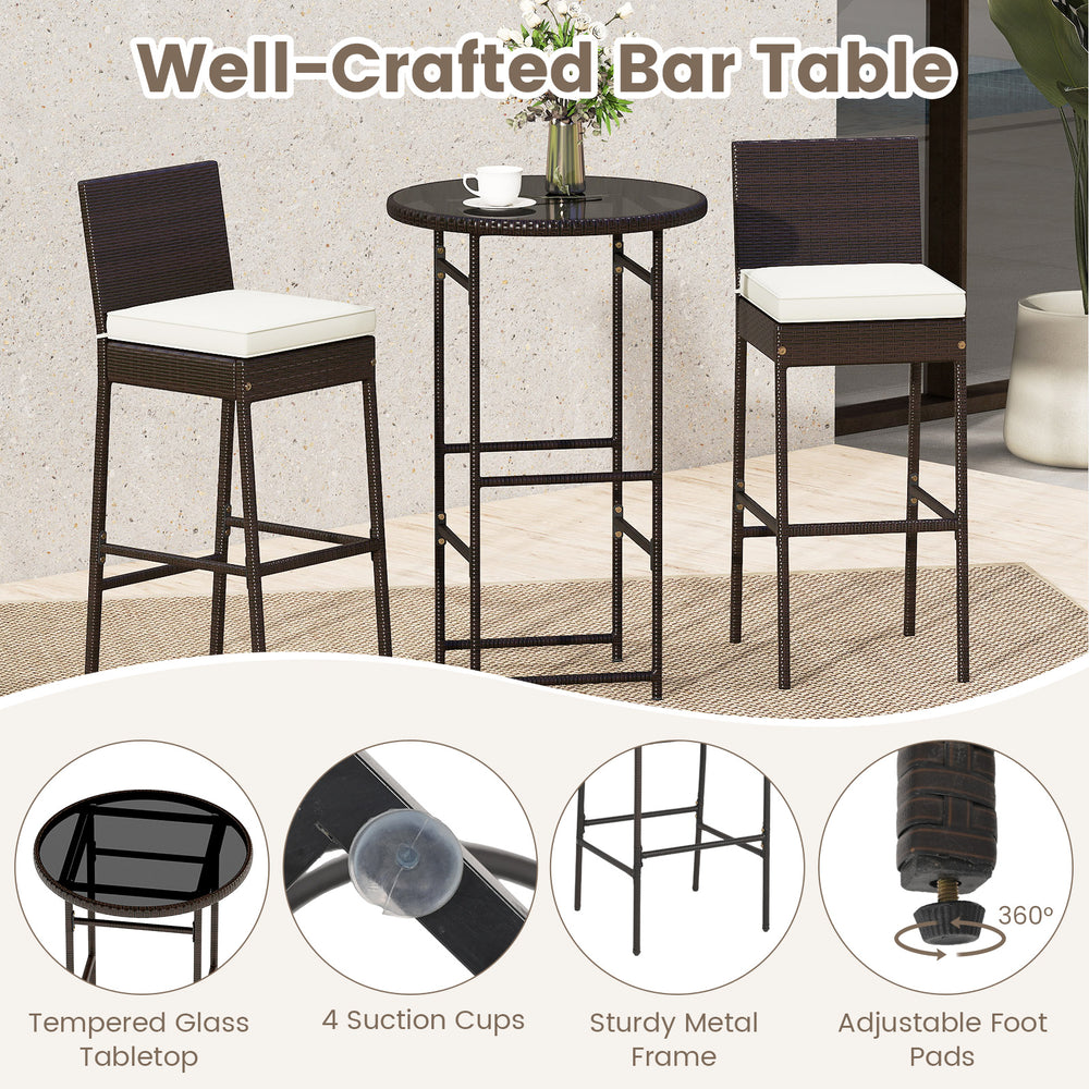 Outdoor bar table with tempered glass top and rattan edge, paired with two barstools featuring soft cushions for.