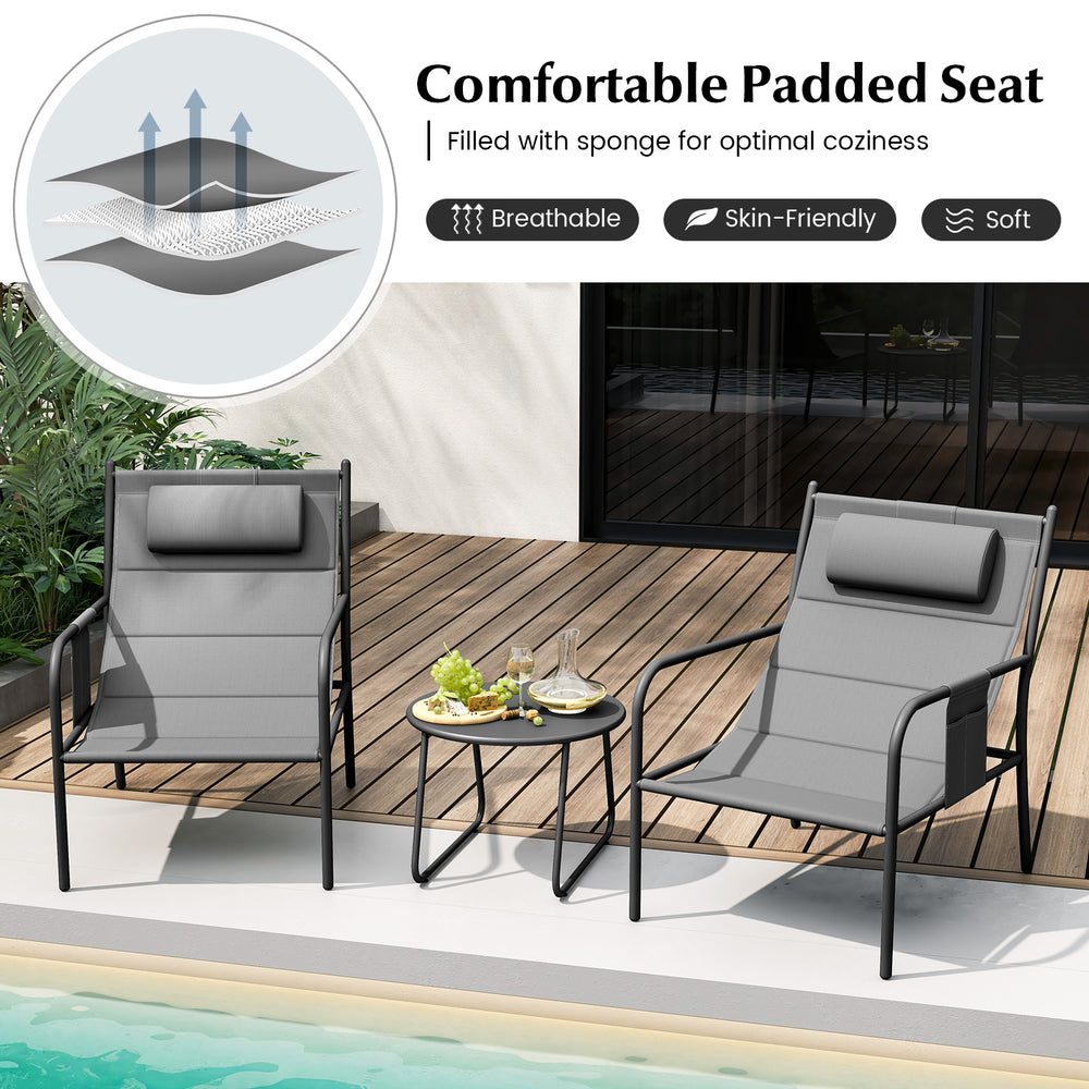 Two gray padded metal chairs with a coffee table, perfect for outdoor relaxation by the poolside or patio.