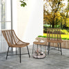 Two ergonomic brown rattan chairs with a side table, perfect for outdoor patio relaxation and pet comfort.