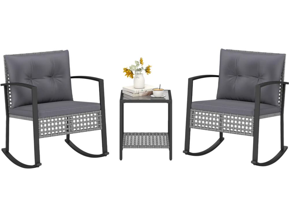 Two gray rocking chairs with thick cushions and a glass-top table create a stylish outdoor conversation set.