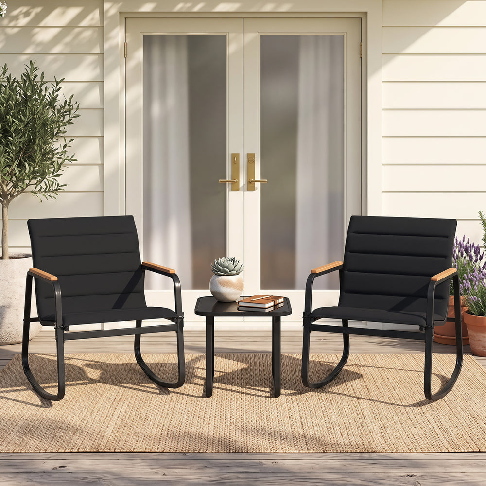 Two black rocking chairs with wooden armrests and a glass top table, perfect for outdoor patio relaxation.
