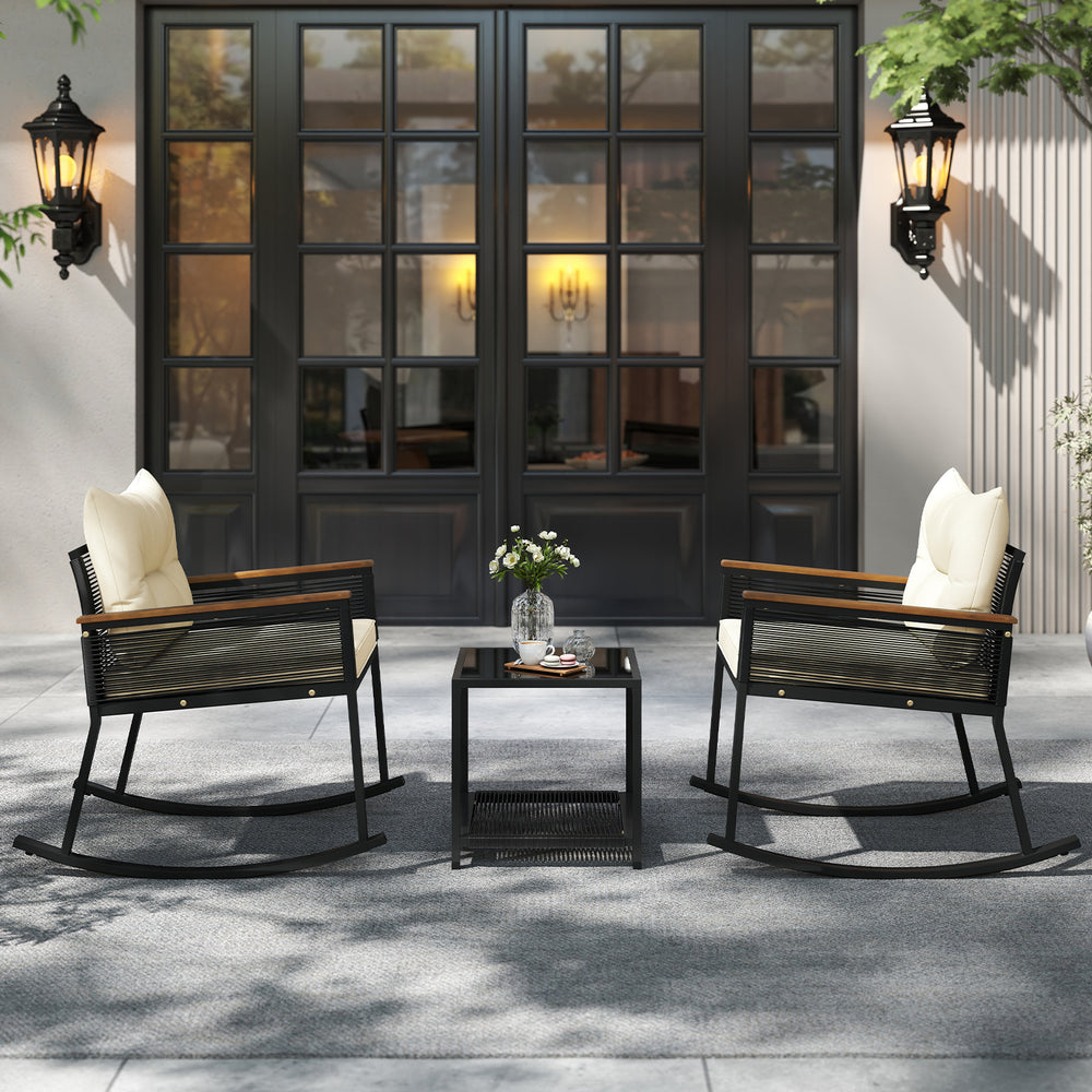 Two rocking chairs with cream cushions and a black coffee table, perfect for outdoor patio relaxation.