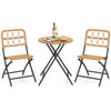 Folding round table and two chairs with handwoven rattan seats, perfect for outdoor patio or poolside relaxation.