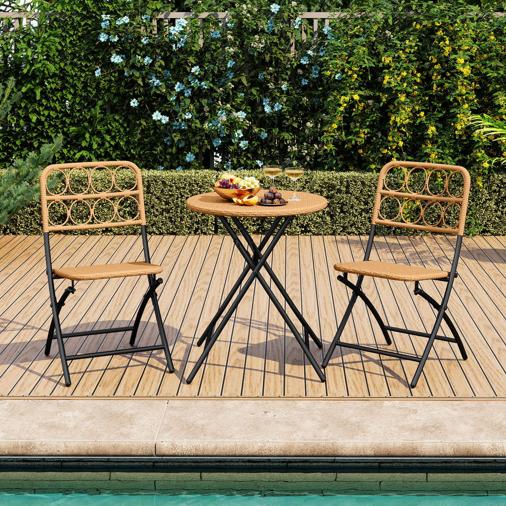 Folding round table and two chairs with handwoven rattan seats, perfect for outdoor patio and poolside relaxation.