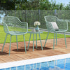 Two green patio chairs with a coffee table, featuring a PP seat and metal frame, perfect for poolside relaxation.
