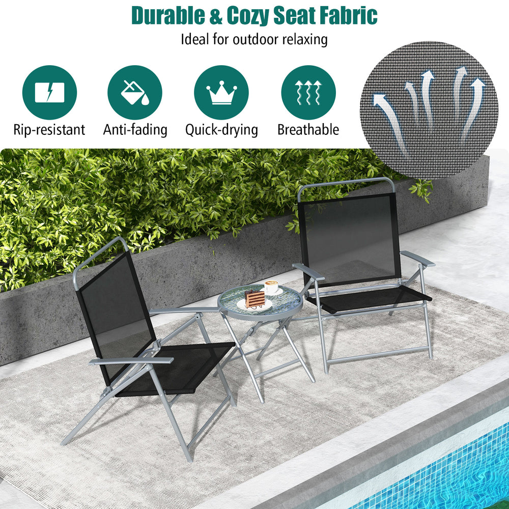 Two black folding chairs with a tempered glass coffee table, perfect for outdoor relaxation in a patio setting.