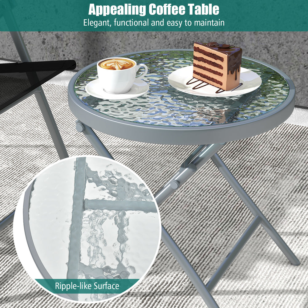 Tempered glass coffee table with ripple-like surface, part of a 3-piece patio folding chair set for outdoor use.