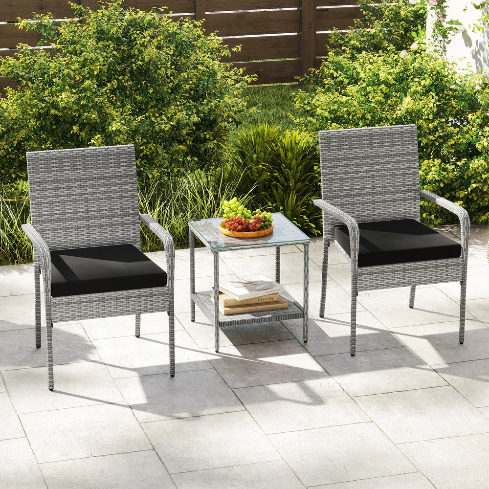 Two ergonomic patio chairs with black cushions and a tempered glass side table, perfect for balcony relaxation.