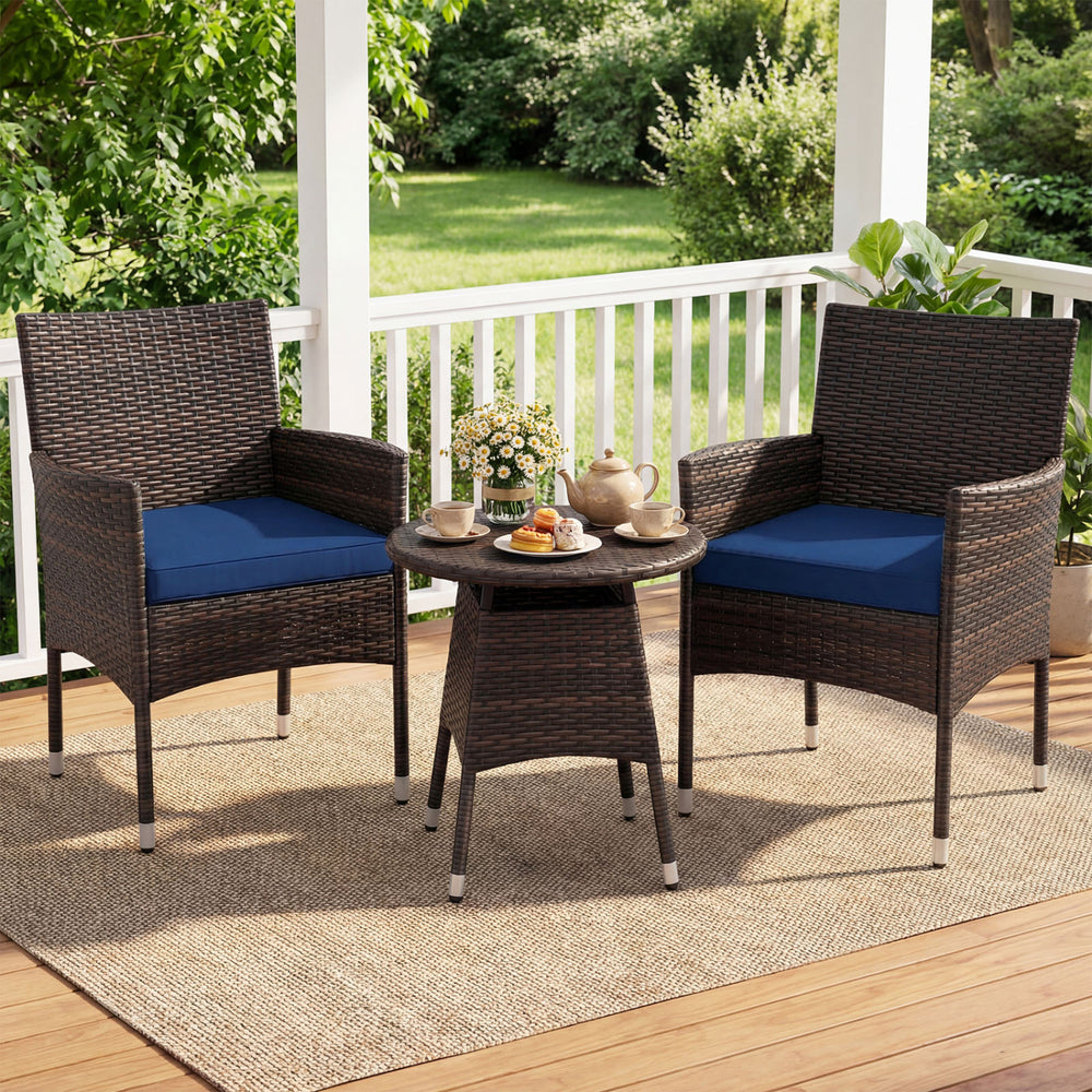 Two navy cushioned chairs and a round table in a 3-piece patio furniture set for outdoor relaxation on a porch.