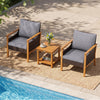 Two gray padded chairs with a slatted acacia wood side table, perfect for relaxing by the poolside or garden.