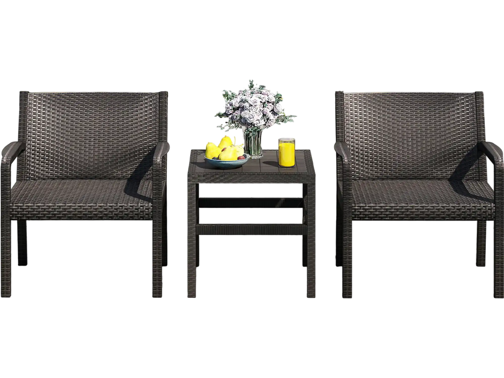 Two modern black rattan armchairs and a square side table by the pool, perfect for outdoor relaxation.