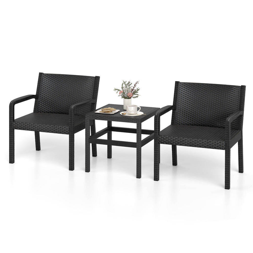 Two black rattan armchairs with a square side table, perfect for outdoor patio use, offering comfort and style.