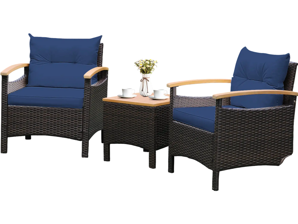 Two navy cushioned patio chairs with a brown rattan finish and acacia wood table, ideal for outdoor relaxation.
