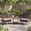Wicker rocking chairs with off-white cushions and a double-tier coffee table, perfect for backyard relaxation.