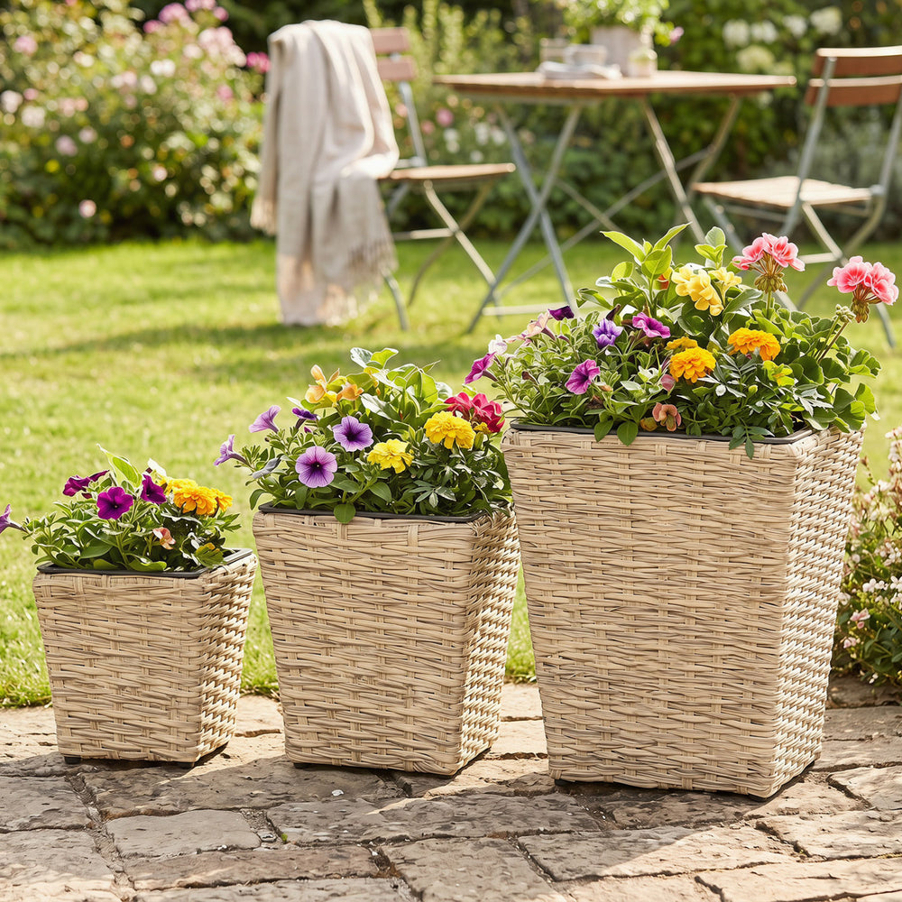 Three sizes of natural rattan planter boxes with removable liners, perfect for planting flowers and herbs outdoors.