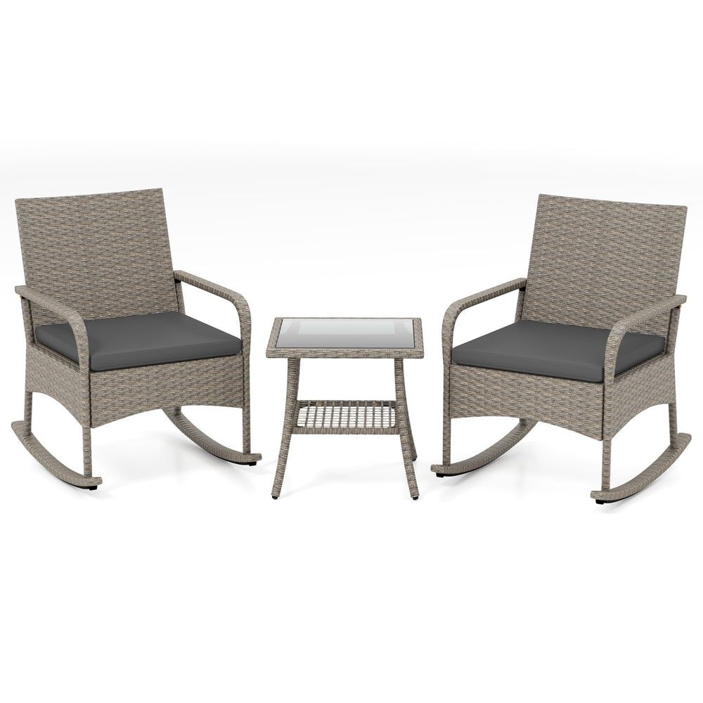 Two gray wicker rocking chairs with cushions and a coffee table, perfect for garden or backyard relaxation.