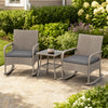Two gray wicker rocking chairs with cushions and a glass-top coffee table, perfect for garden or patio relaxation.