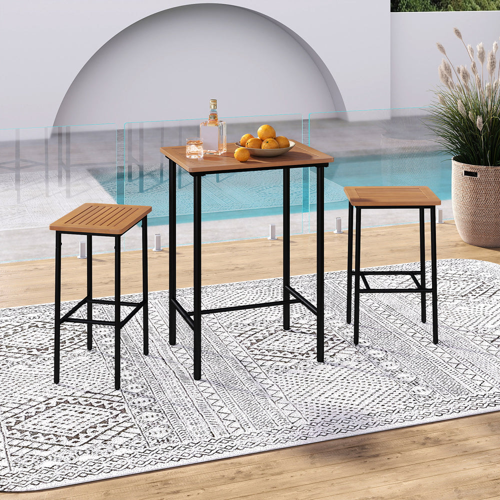 Acacia wood patio bar set featuring a rectangular table and two stools, perfect for outdoor relaxation by the poolside.