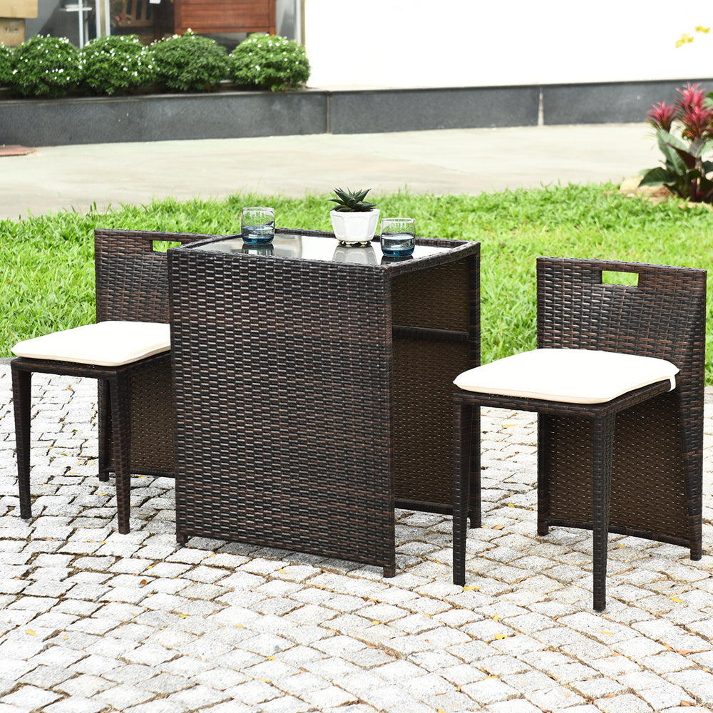Cushioned wicker patio bistro set featuring a strong steel frame, ideal for outdoor spaces like gardens or poolside.