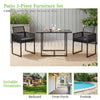 Outdoor dining set featuring a black metal frame, hand-woven PE rattan, and soft cushions, ideal for backyard.