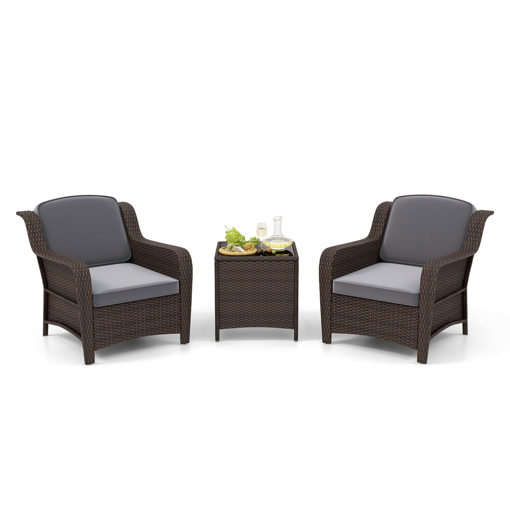 Two gray cushioned outdoor rattan chairs with a tempered glass coffee table, perfect for garden or balcony relaxation.