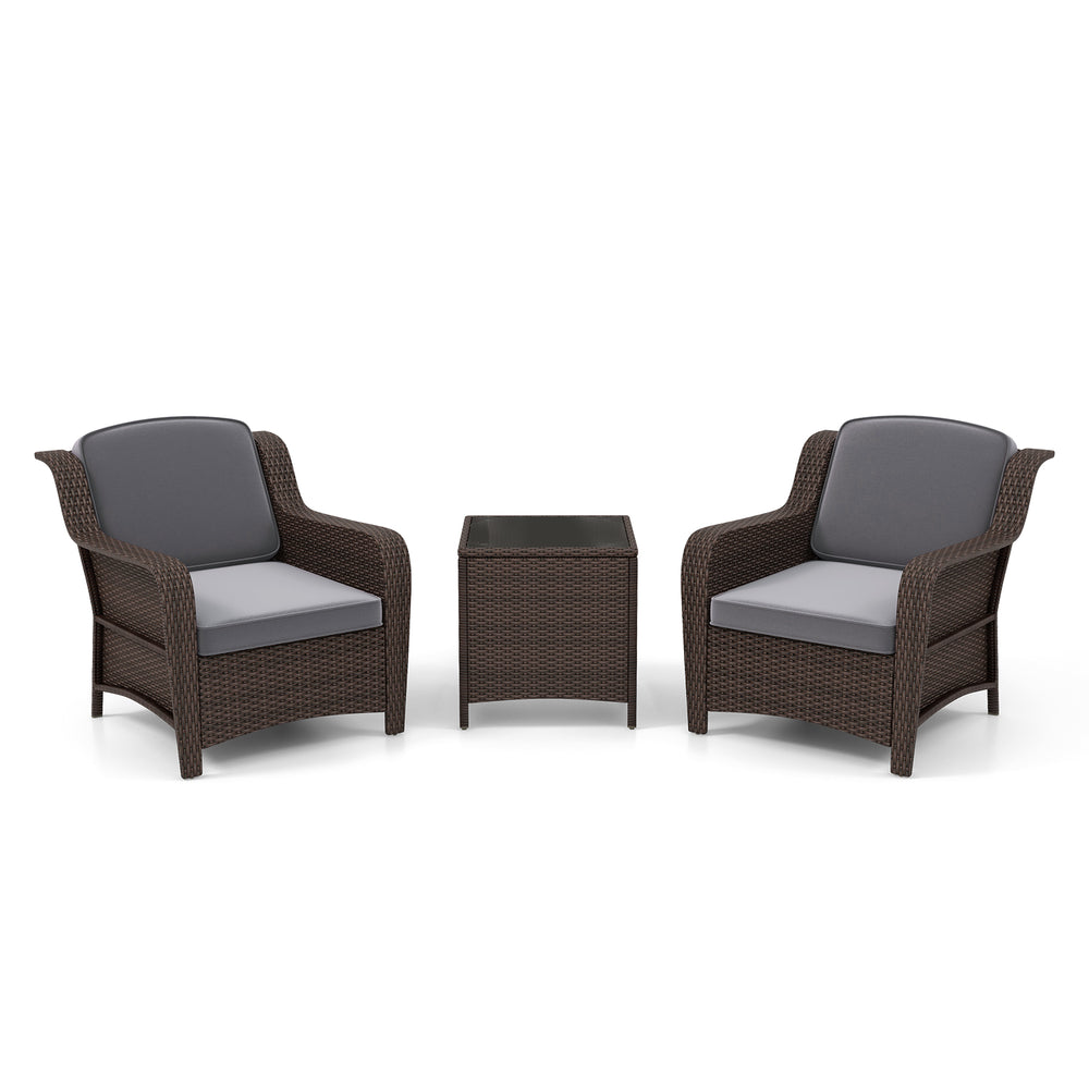 Two gray cushioned outdoor rattan chairs with a tempered glass coffee table, perfect for patio relaxation.