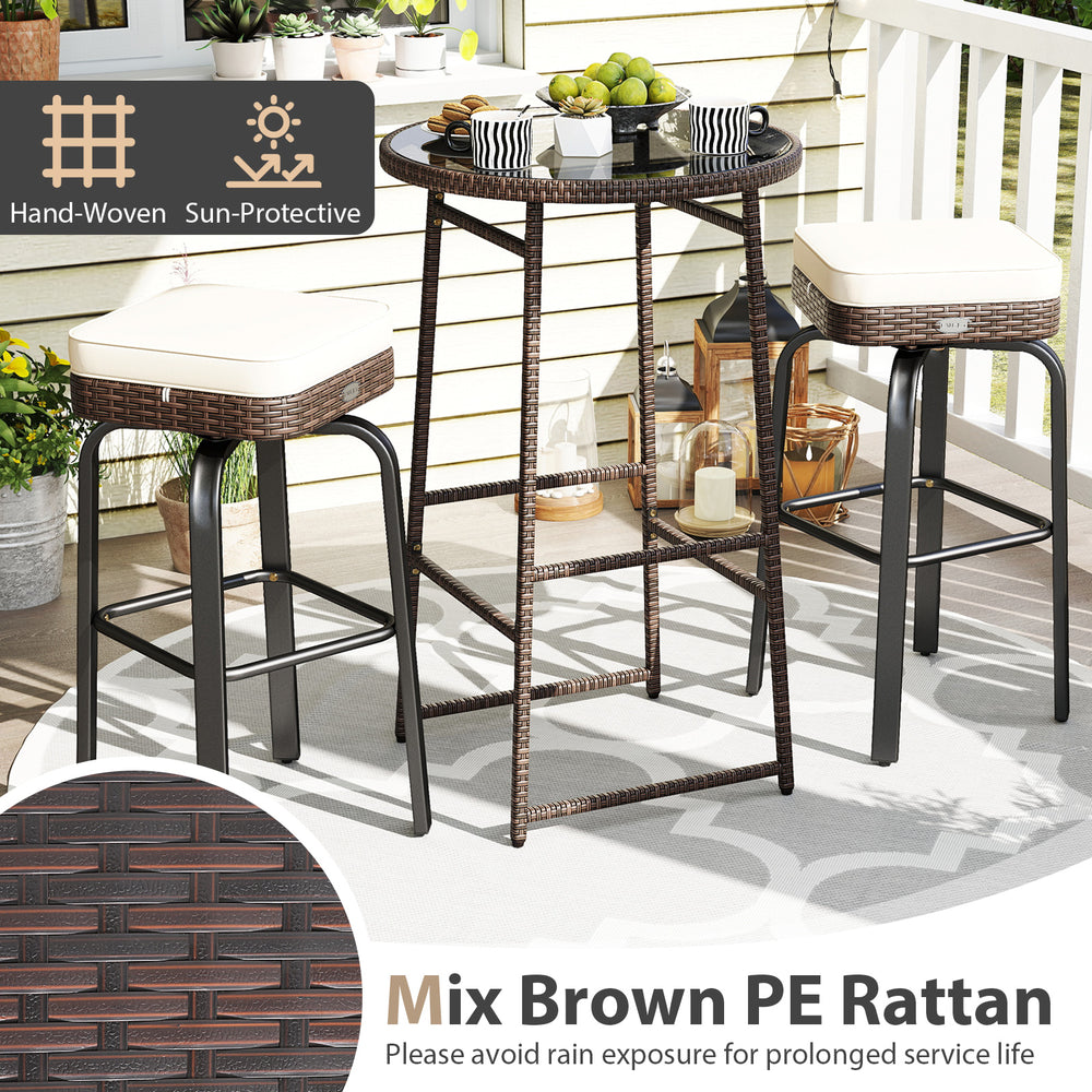 Outdoor swivel bar set featuring a PE rattan table and two chairs with white cushions, perfect for patio relaxation.