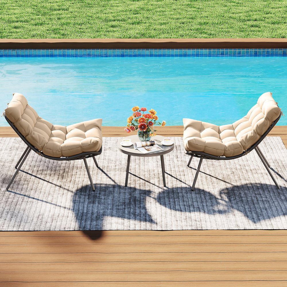 Cushioned papasan chairs in beige with a side table, perfect for outdoor lounging by the pool.