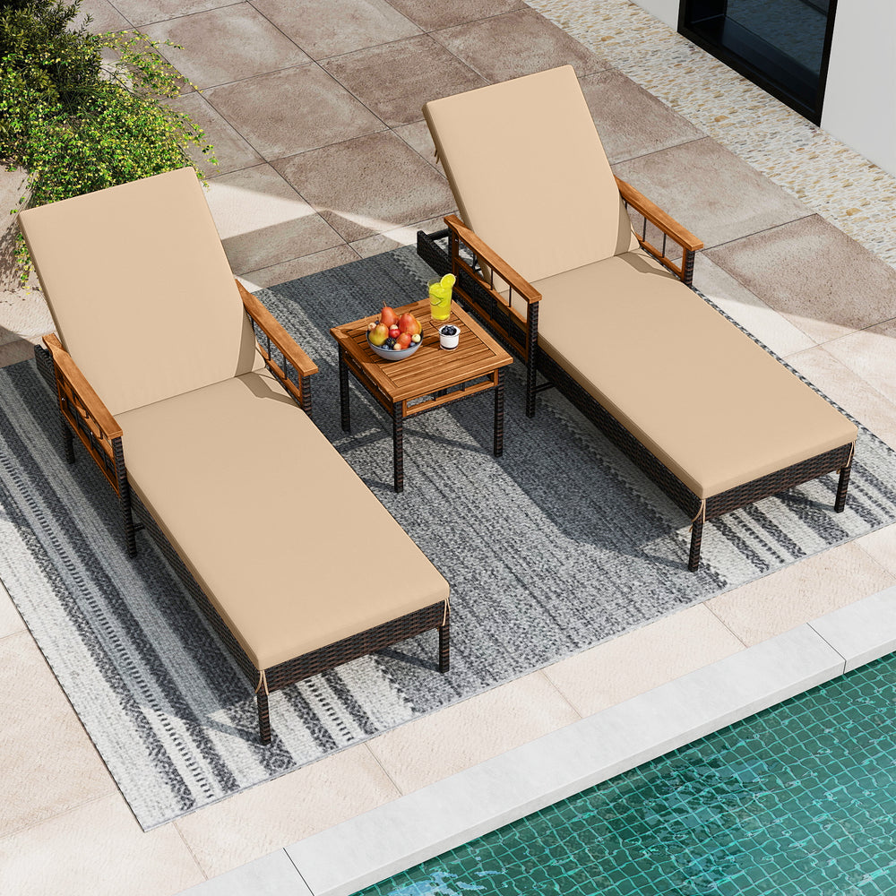 Two adjustable chaise lounges with soft cushions and a side table, made of PE rattan and acacia wood, for poolside.