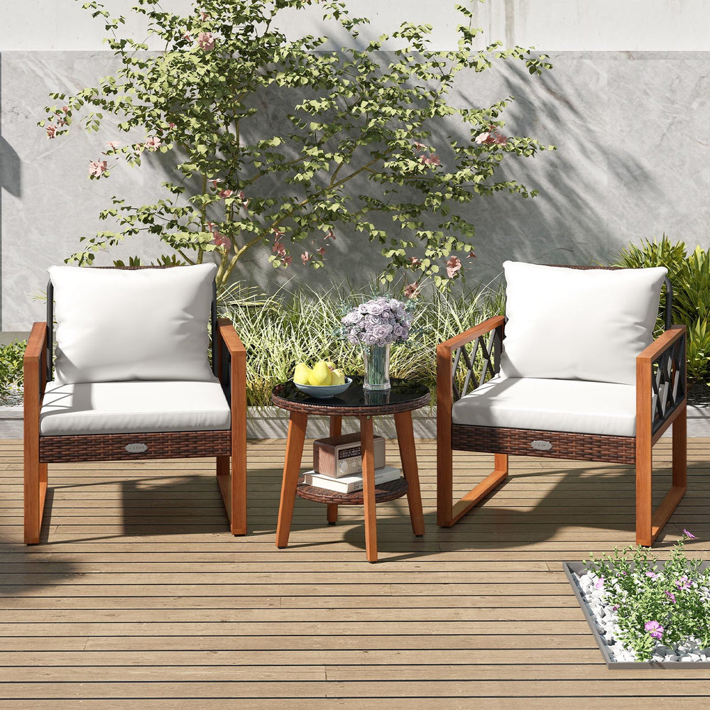 Two acacia wood armchairs with off-white cushions and a tempered glass top table, perfect for outdoor relaxation.
