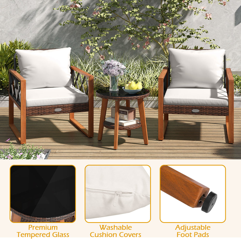 Two acacia wood chairs with soft off-white cushions and a tempered glass table, perfect for outdoor patio relaxation.