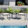 Two PE rattan patio chairs with white cushions and a round tempered glass table, perfect for poolside relaxation.