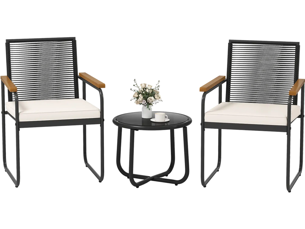 Two patio chairs with white cushions and a round tempered glass table, featuring PE rattan and acacia wood armrests.