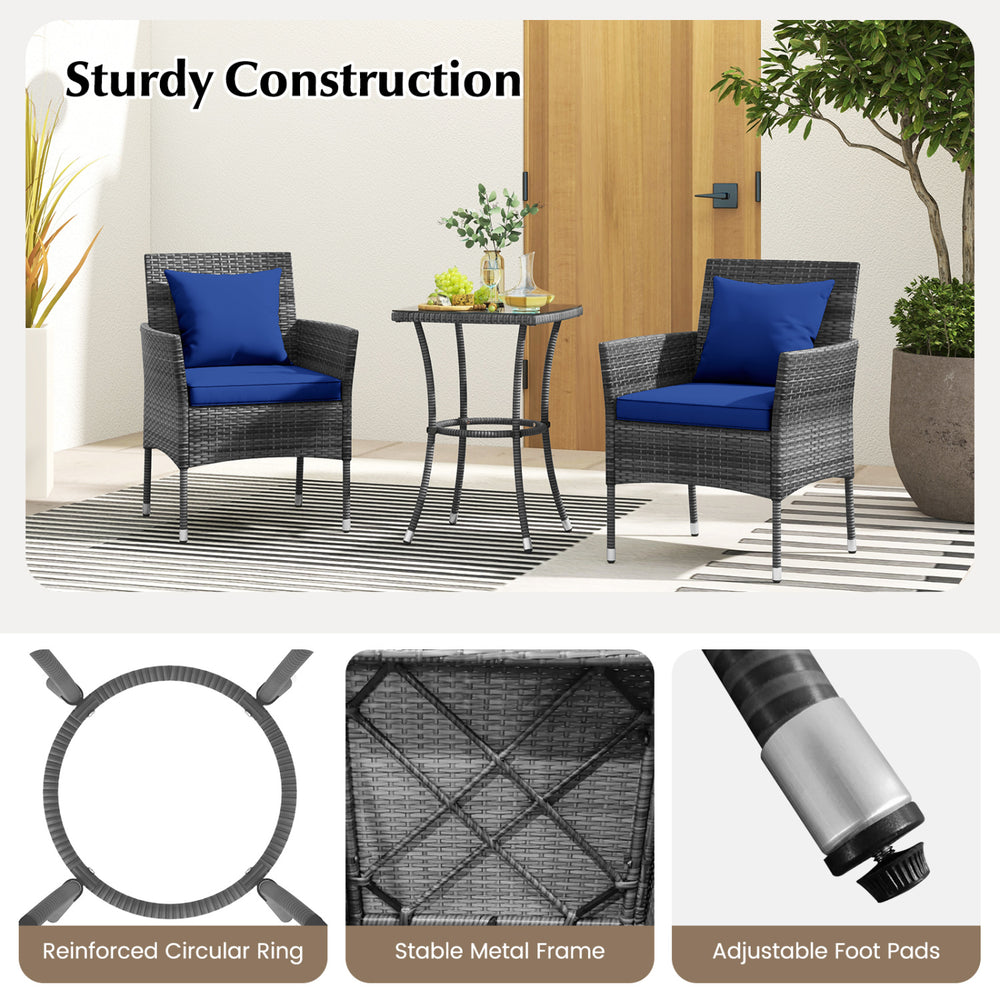 Cushioned patio chairs and tempered glass coffee table in navy, featuring durable PE rattan for outdoor use.