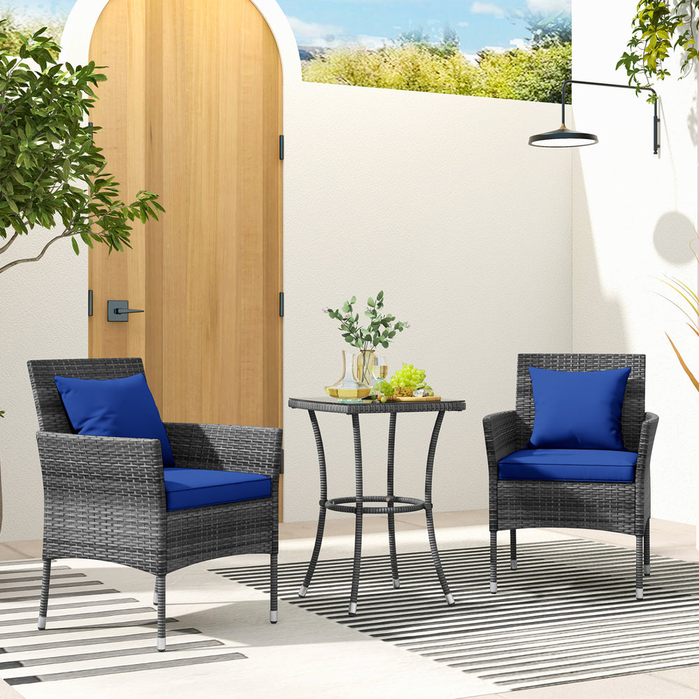 Cushioned patio chairs with navy cushions and a tempered glass coffee table, perfect for outdoor relaxation.