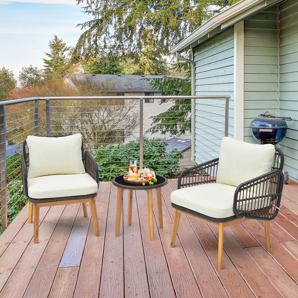 Cushioned patio chairs and tempered glass side table in black, perfect for outdoor relaxation on a balcony or porch.
