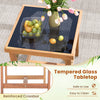 Square tempered glass tabletop with acacia wood frame, featuring a reinforced crossbar for stability, ideal for outdoor.