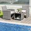 Two chairs and a coffee table in gray PE rattan with soft cushions, perfect for poolside relaxation.