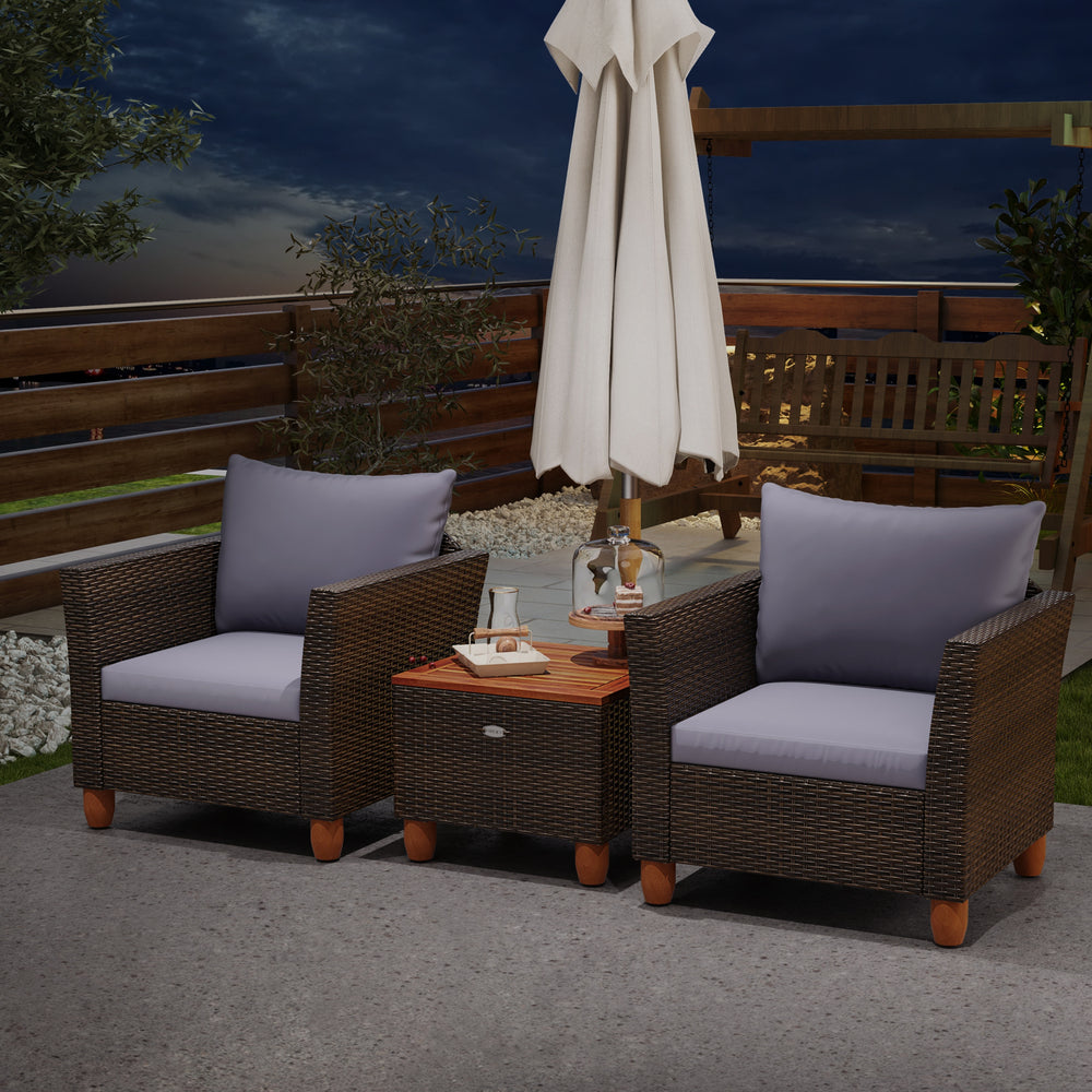 Two gray cushioned patio chairs with a wooden table, made of PE rattan, perfect for outdoor relaxation.
