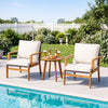 Two off-white cushioned chairs and a round acacia wood table, perfect for outdoor patio relaxation by the poolside.