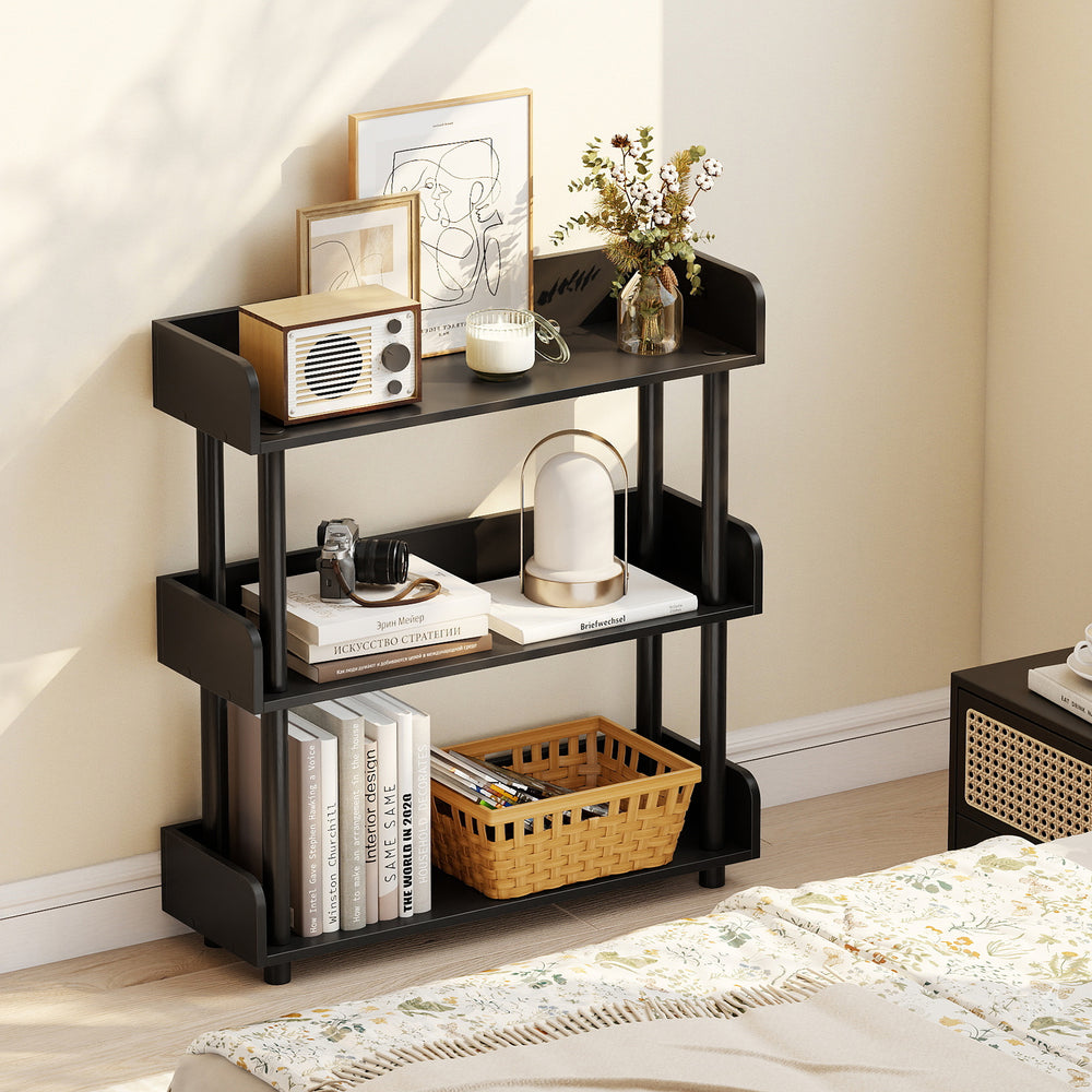 Black 3-tier bookshelf with elevated legs and anti-falling guardrails, perfect for organizing books and decor in any.