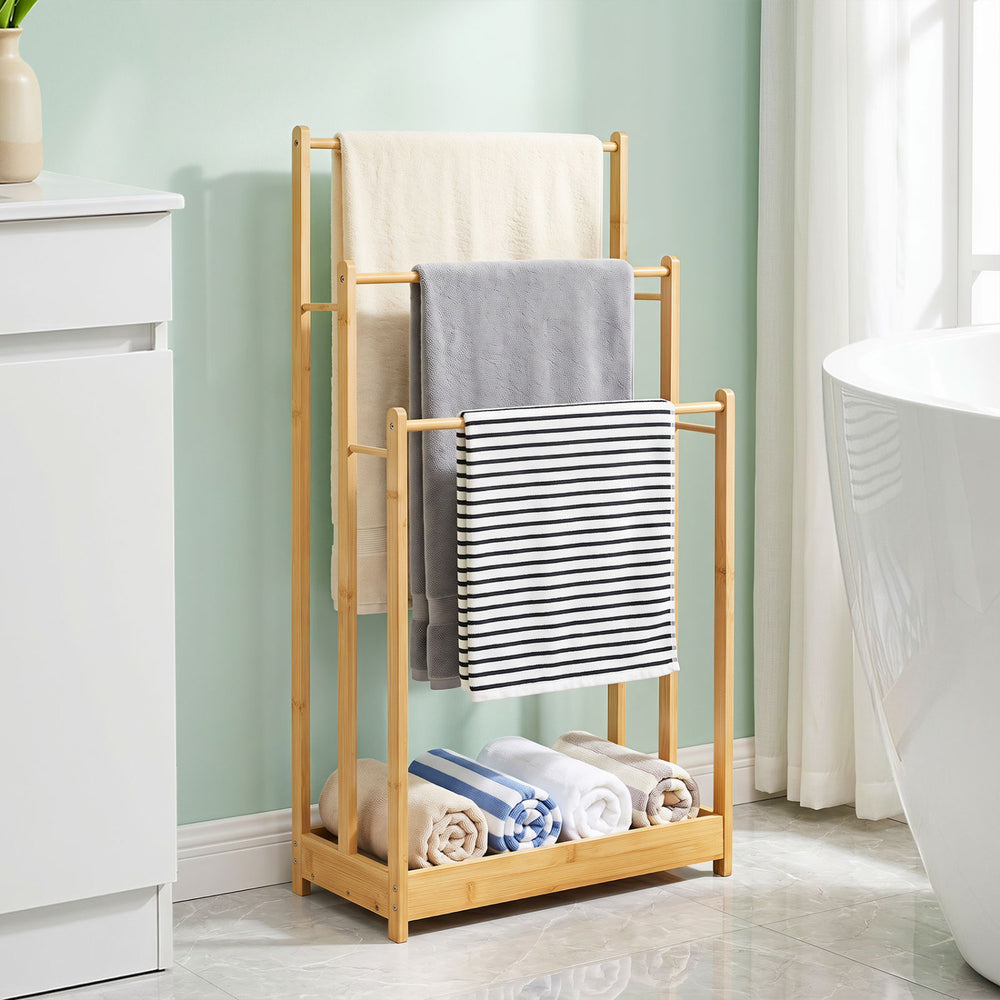 Three-tier free-standing bamboo towel rack with storage shelf, featuring ample hanging space and a waterproof surface for easy cleaning.