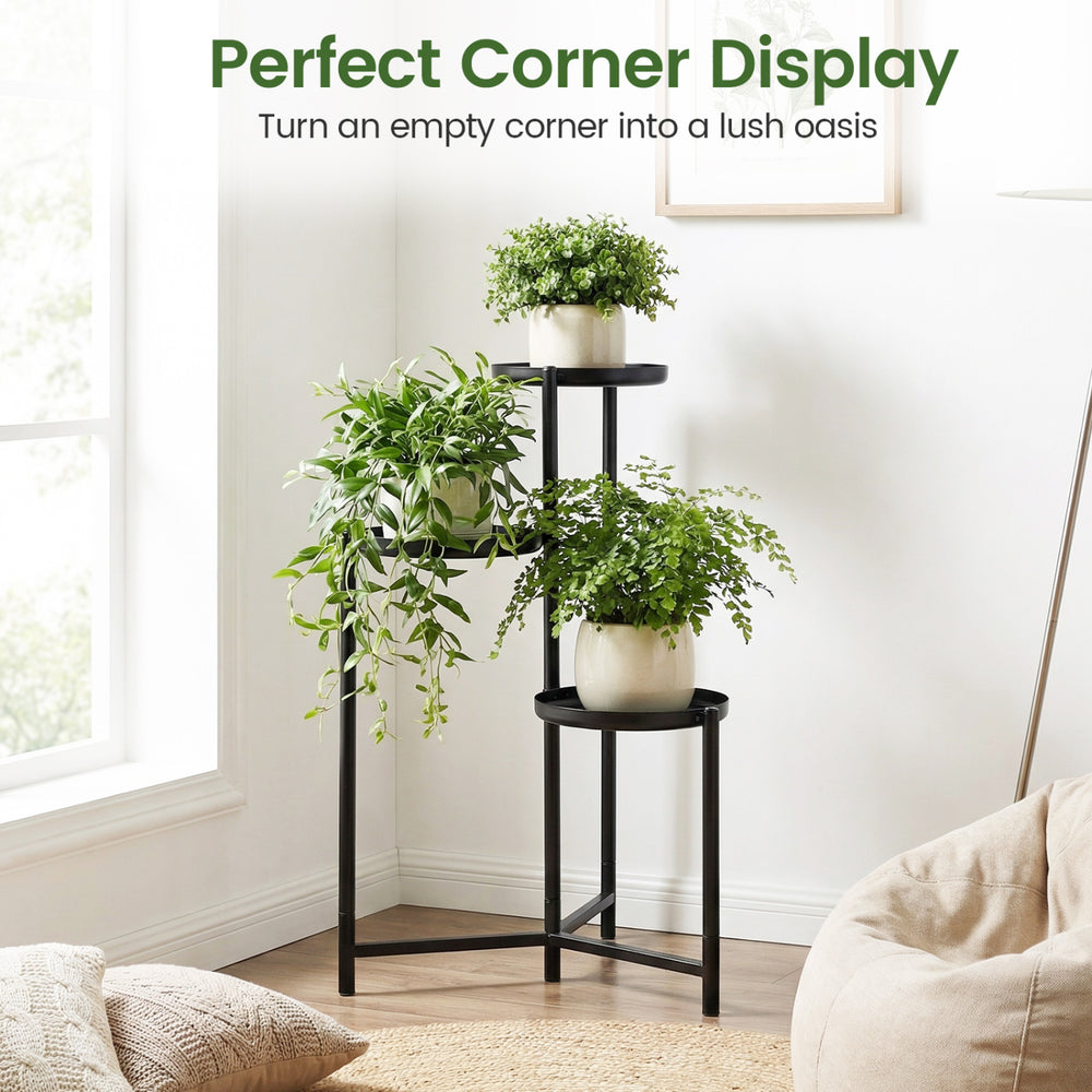 3-tier metal plant stand in black, showcasing potted plants, ideal for corner display in indoor or outdoor spaces.