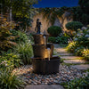 Three-tier outdoor barrel waterfall fountain with vintage bronze finish, cascading water, and decorative pump for garden relaxation.