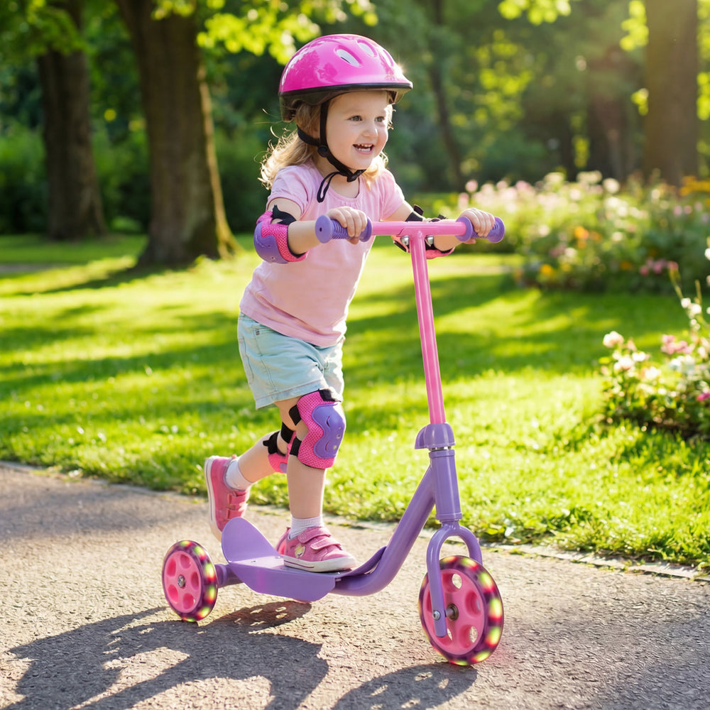 Child riding a purple 3-wheel scooter with LED light-up wheels, designed for stability and safety for kids age 2+.