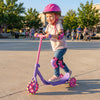 Child riding a purple 3-wheel scooter with LED light-up wheels, designed for stability and safety, perfect for outdoor.
