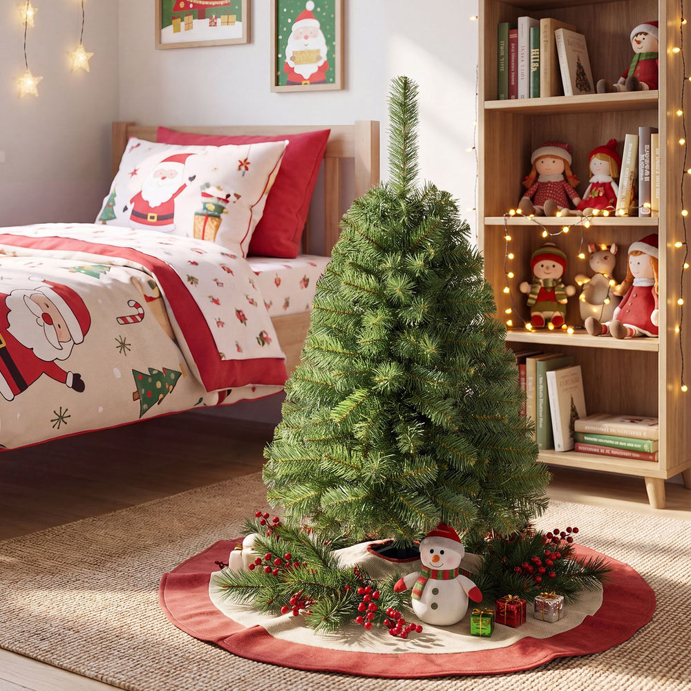 3 ft pre-lit artificial mini Christmas tree surrounded by festive decorations, adding charm to any holiday setting.