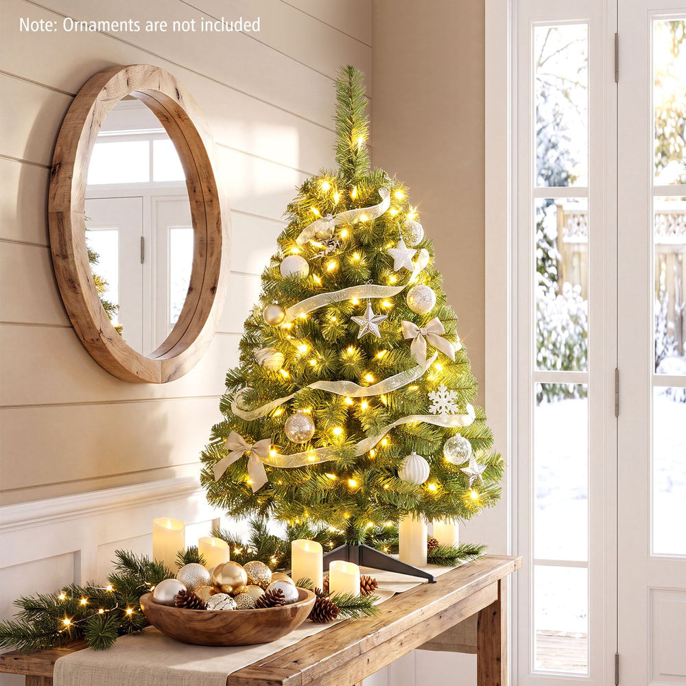 3 ft pre-lit artificial mini Christmas tree decorated with warm white LED lights, ideal for tabletops and cozy holiday settings.