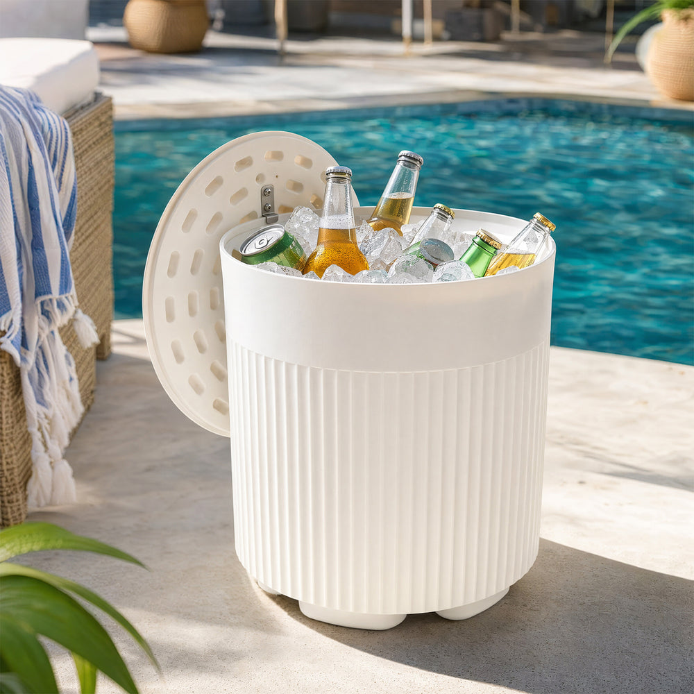 The white 3-in-1 outdoor cooler side table features a fluted design and holds up to 6.2 gallons for drinks by the pool.